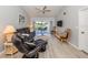 Bright and airy living room with comfortable seating and sliding glass doors to the balcony at 421 Cerromar Ter # 471, Venice, FL 34293