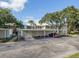 Community parking area with carports and well-maintained landscaping around the complex at 421 Cerromar Ter # 471, Venice, FL 34293