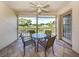 Screened-in lanai providing tranquil golf course views, a table with four chairs, and a ceiling fan at 421 Cerromar Ter # 471, Venice, FL 34293