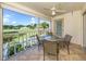 Screened lanai featuring a ceiling fan, table with four chairs, and picturesque views of the golf course at 421 Cerromar Ter # 471, Venice, FL 34293