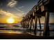 Picturesque pier view at sunset, perfect for leisurely strolls and enjoying the ocean scenery at 421 Cerromar Ter # 471, Venice, FL 34293