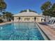 Gorgeous community pool with inviting clear water, sun loungers, and a charming cabana for relaxation and socializing at 421 Cerromar Ter # 471, Venice, FL 34293
