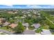 Serene aerial view of homes nestled around a pond, surrounded by lush greenery at 427 Autumn Chase Dr, Venice, FL 34292