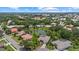 Beautiful aerial view of a residential area with a pond and mature trees providing privacy at 427 Autumn Chase Dr, Venice, FL 34292