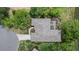 An aerial view of the home featuring a screened-in lanai, lush landscaping and a pond at 427 Autumn Chase Dr, Venice, FL 34292