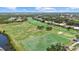 Expansive aerial view showcasing the lush green golf course and surrounding community at 427 Autumn Chase Dr, Venice, FL 34292