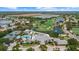Stunning aerial view of a community with golf course, pool, tennis courts, and beautiful landscaping at 427 Autumn Chase Dr, Venice, FL 34292