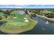 Picturesque aerial view of a golf course with a scenic lake and water fountain feature at 427 Autumn Chase Dr, Venice, FL 34292