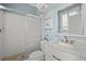 Bathroom with marble sink and countertop, tiled floors, and a glass door shower at 427 Autumn Chase Dr, Venice, FL 34292