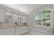Bathroom featuring double sinks, granite countertops, and a built-in window bench at 427 Autumn Chase Dr, Venice, FL 34292