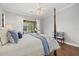 Comfortable primary bedroom with a view of screened patio and outdoor seating at 427 Autumn Chase Dr, Venice, FL 34292