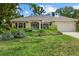 Charming home with lush landscaping, a well-maintained lawn, and a welcoming facade at 427 Autumn Chase Dr, Venice, FL 34292