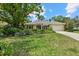 Well-maintained home featuring lush landscaping, a paved driveway, and a two-car garage at 427 Autumn Chase Dr, Venice, FL 34292