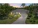 Exterior dusk view of a home with well-manicured landscaping, a paved driveway and a two-car garage at 427 Autumn Chase Dr, Venice, FL 34292