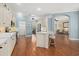 Bright kitchen featuring white cabinets, stainless steel appliances, with island and bar stool seating at 427 Autumn Chase Dr, Venice, FL 34292