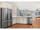Gourmet kitchen features a large refrigerator, stainless steel appliances, and access to the backyard at 427 Autumn Chase Dr, Venice, FL 34292