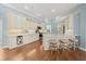 Open kitchen boasts modern cabinets, a kitchen island with seating, and stainless steel appliances at 427 Autumn Chase Dr, Venice, FL 34292