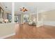 Spacious living room with hardwood floors, stylish columns, and a view into other living areas at 427 Autumn Chase Dr, Venice, FL 34292