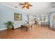 Open-concept living room flowing into modern kitchen with breakfast bar seating at 427 Autumn Chase Dr, Venice, FL 34292