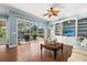Bright living room with hardwood floors, built-in shelving, and view of outdoor patio at 427 Autumn Chase Dr, Venice, FL 34292