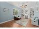 Office space featuring custom built-in shelving and cabinets, a ceiling fan, and a large window at 427 Autumn Chase Dr, Venice, FL 34292