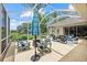 The screened patio featuring comfortable furniture for relaxing and enjoying the outdoor view at 427 Autumn Chase Dr, Venice, FL 34292