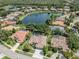 Beautiful aerial view of single-Gathering home with pool in gated community near a lake at 463 Park Trace Blvd, Osprey, FL 34229