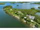 Aerial view of a home nestled among lush greenery, with waterfront views and a private island ambiance at 463 Park Trace Blvd, Osprey, FL 34229