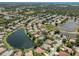 Gorgeous aerial view of large community with lake, mature trees, and lush landscaping at 463 Park Trace Blvd, Osprey, FL 34229
