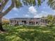 Expansive backyard with a screened lanai, pool, and lake view provides ultimate privacy and relaxation at 463 Park Trace Blvd, Osprey, FL 34229