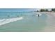 Scenic beach view featuring crystal clear turquoise waters, soft white sand, and people enjoying recreational activities at 463 Park Trace Blvd, Osprey, FL 34229