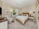 Comfortable bedroom with palm tree themed decor, neutral walls, and a ceiling fan at 463 Park Trace Blvd, Osprey, FL 34229