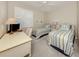 Cozy bedroom featuring twin beds with striped bedding and shuttered window at 463 Park Trace Blvd, Osprey, FL 34229