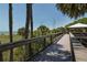 Elevated wooden boardwalk offers stunning views of the beach and surrounding lush tropical vegetation at 463 Park Trace Blvd, Osprey, FL 34229
