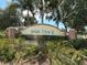 The entrance sign to Park Trace is surrounded by lush landscaping and mature trees at 463 Park Trace Blvd, Osprey, FL 34229