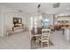 Elegant dining room with stylish furniture, views of the lake, and access to the living room at 463 Park Trace Blvd, Osprey, FL 34229