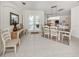 Bright dining room flows into living spaces with a view to the lanai and pool at 463 Park Trace Blvd, Osprey, FL 34229