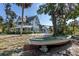 Charming historic home featuring a spacious front porch, mature trees, and a boat on blocks in the front yard at 463 Park Trace Blvd, Osprey, FL 34229