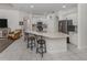 Bright, open kitchen featuring a large island with seating and stainless steel appliances at 463 Park Trace Blvd, Osprey, FL 34229