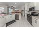 Well-designed kitchen with stainless appliances, a breakfast bar and an adjacent casual living space at 463 Park Trace Blvd, Osprey, FL 34229