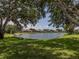 Serene lake view from this home offers a tranquil escape, surrounded by mature trees and lush landscaping at 463 Park Trace Blvd, Osprey, FL 34229