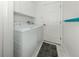 Well-lit laundry room featuring a modern washer and dryer set and white cabinets at 463 Park Trace Blvd, Osprey, FL 34229
