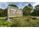 Oscar Scherer State Park sign surrounded by lush greenery, grasses and mature trees at 463 Park Trace Blvd, Osprey, FL 34229