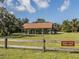 Legacy Trail picnic area with picnic tables and a barbecue pit surrounded by trees at 463 Park Trace Blvd, Osprey, FL 34229