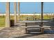 Beachside picnic area featuring tables and benches, framed by concrete columns and a view of the ocean at 463 Park Trace Blvd, Osprey, FL 34229