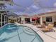 Enjoy a luxurious outdoor experience with a screened pool, and a serene view of the lake at 463 Park Trace Blvd, Osprey, FL 34229
