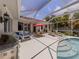 Covered patio with a pool, outdoor seating, and a barbecue grill at 463 Park Trace Blvd, Osprey, FL 34229