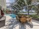 Screened-in pool and patio area with outdoor seating and lake view at 463 Park Trace Blvd, Osprey, FL 34229
