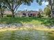 A waterfront property featuring a screened lanai and lush greenery at 463 Park Trace Blvd, Osprey, FL 34229