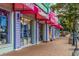 Charming row of local shops with colorful facades and awnings, offering a variety of beach apparel and goods at 463 Park Trace Blvd, Osprey, FL 34229
